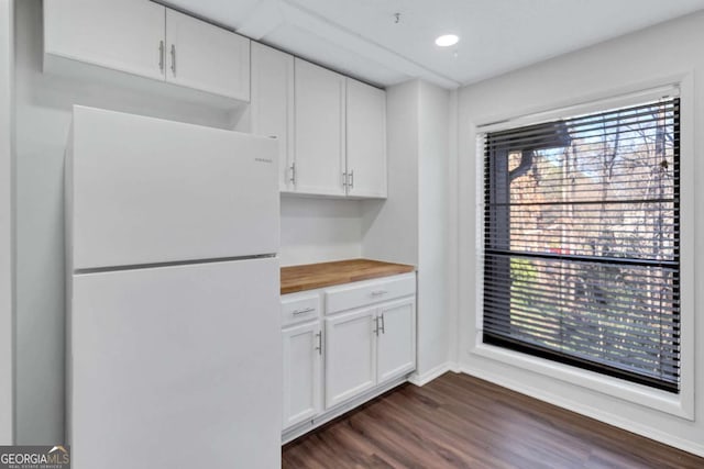 kitchen featuring wood counters, white cabinetry, dark hardwood / wood-style floors, and white fridge