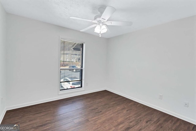 spare room featuring a textured ceiling, ceiling fan, and dark hardwood / wood-style flooring