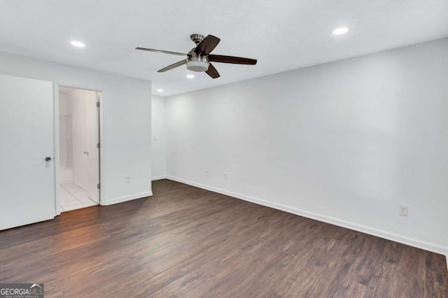 empty room with ceiling fan and dark wood-type flooring