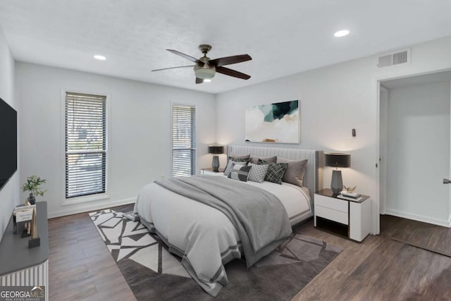 bedroom featuring ceiling fan and dark hardwood / wood-style floors