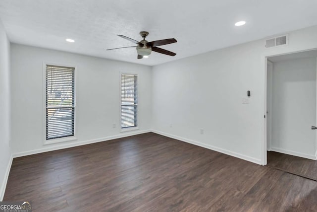 empty room featuring ceiling fan and dark wood-type flooring