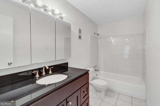 full bathroom featuring tile patterned floors, bathing tub / shower combination, a textured ceiling, toilet, and vanity