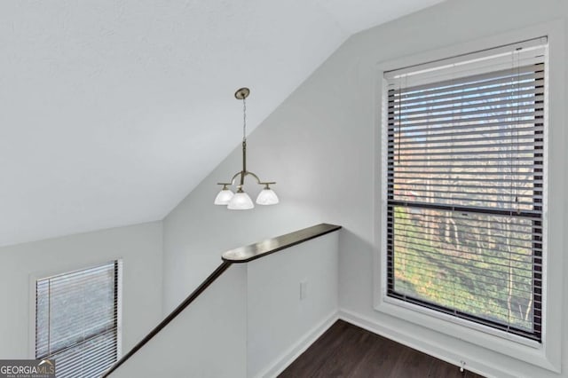 interior details featuring hardwood / wood-style flooring and an inviting chandelier