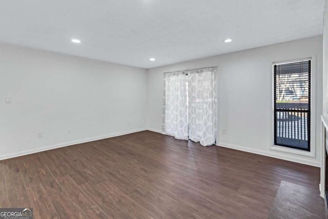 spare room featuring dark hardwood / wood-style flooring