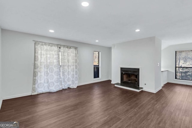 unfurnished living room with dark wood-type flooring