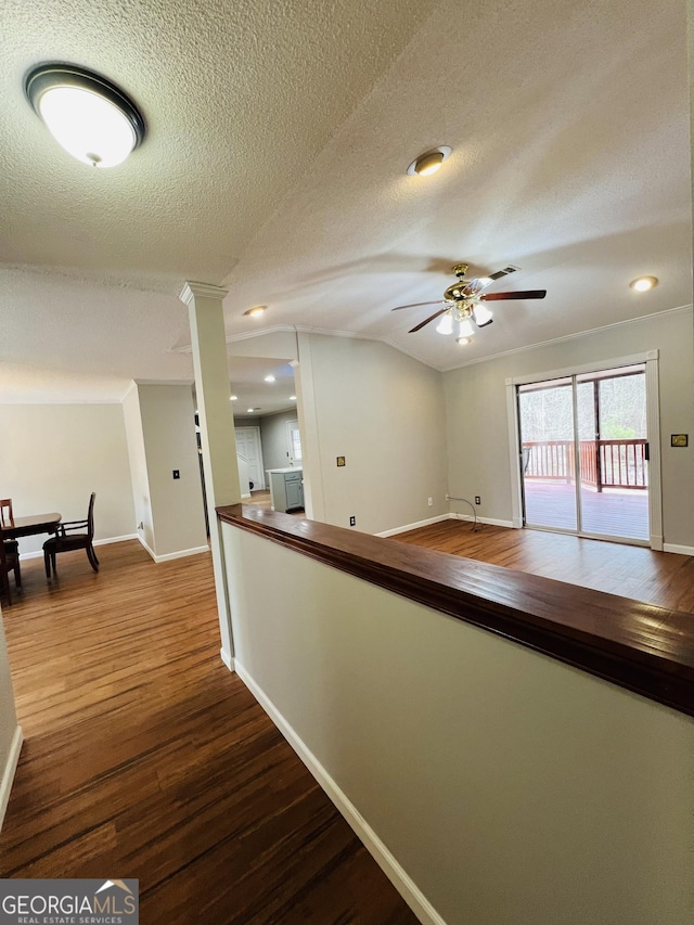 hall featuring wood-type flooring and a textured ceiling