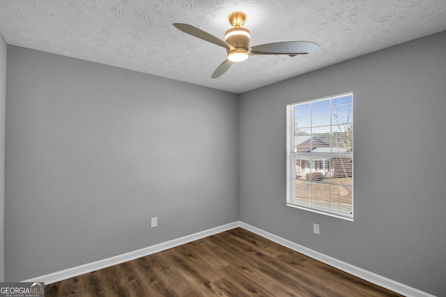 unfurnished room with dark wood-type flooring, ceiling fan, and a textured ceiling