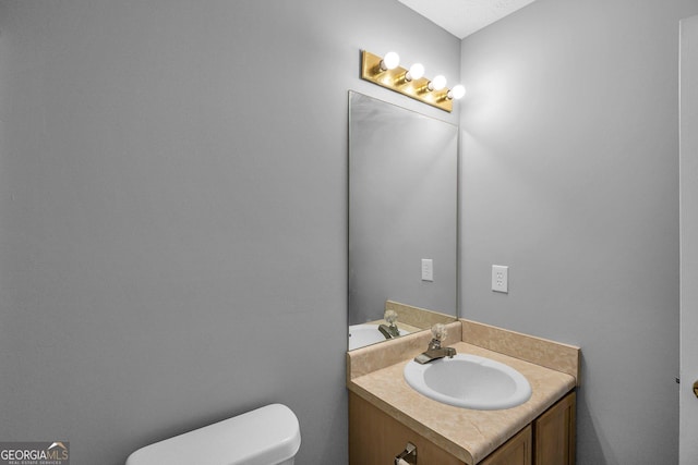 bathroom with vanity and toilet