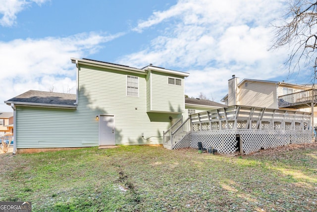 rear view of house with a yard and a sunroom