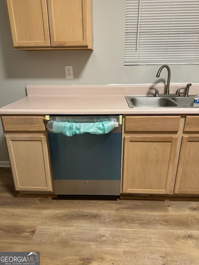 kitchen featuring dishwashing machine, sink, light hardwood / wood-style floors, and light brown cabinetry