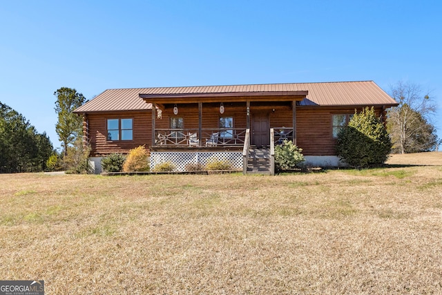 log-style house featuring covered porch and a front lawn