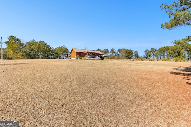 view of yard with a rural view