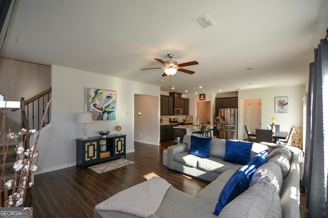 living room with dark hardwood / wood-style floors and ceiling fan