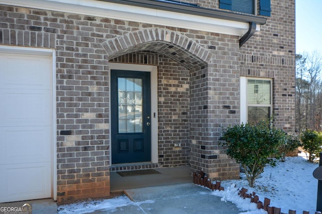 view of snow covered property entrance