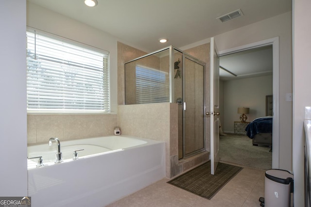 bathroom with shower with separate bathtub and tile patterned floors