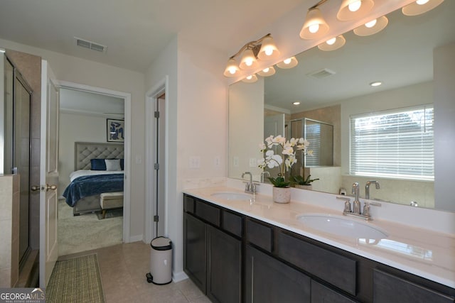 bathroom with vanity, a shower with shower door, and tile patterned flooring