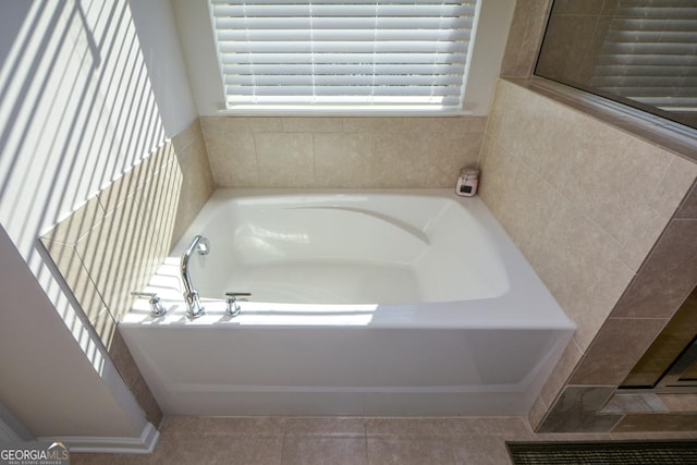 bathroom featuring a tub to relax in and tile patterned floors