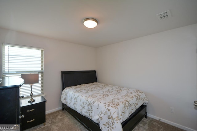 bedroom featuring multiple windows and carpet