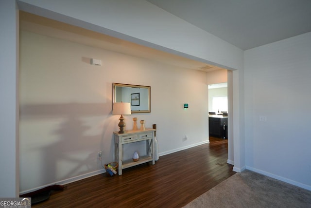 corridor featuring dark hardwood / wood-style floors