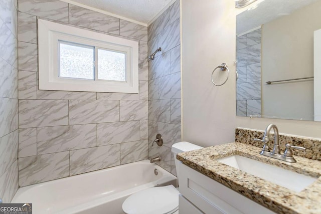 full bathroom featuring vanity, toilet, tiled shower / bath, and a textured ceiling