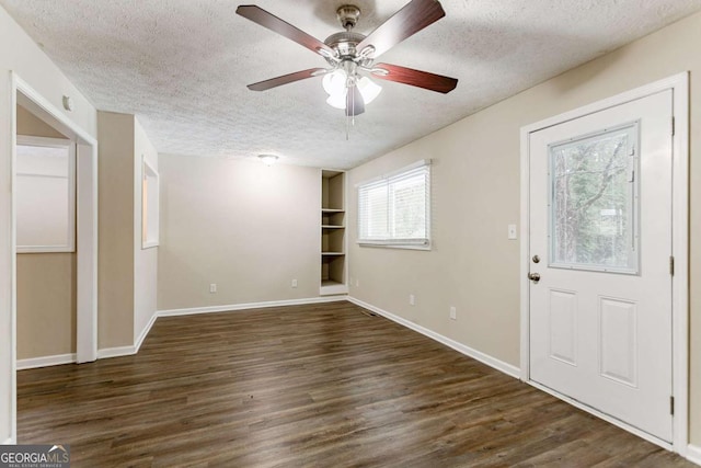 entrance foyer featuring a textured ceiling, dark hardwood / wood-style floors, and ceiling fan