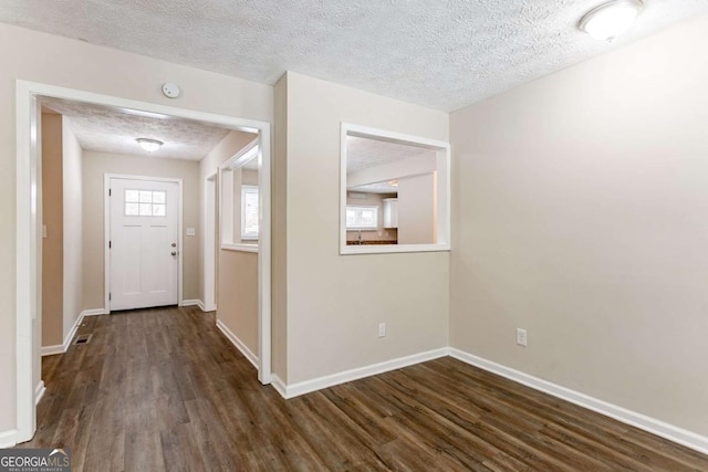 entryway featuring a textured ceiling and dark hardwood / wood-style floors