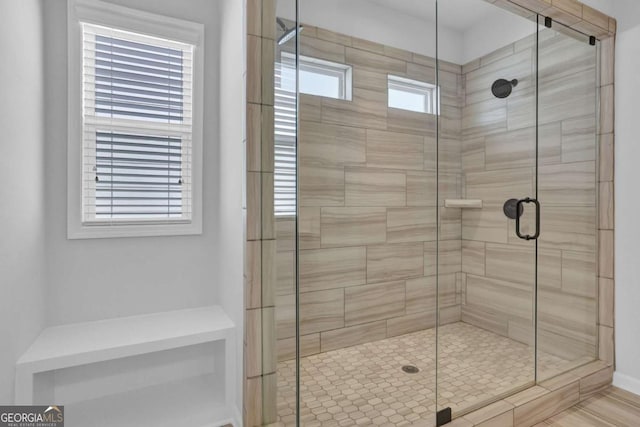 bathroom featuring a shower with shower door