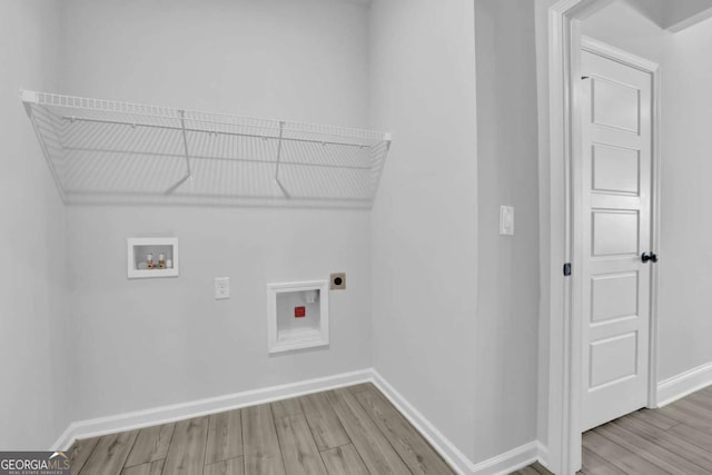 clothes washing area featuring hookup for a washing machine, electric dryer hookup, and light wood-type flooring