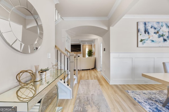 entrance foyer featuring light hardwood / wood-style flooring and crown molding