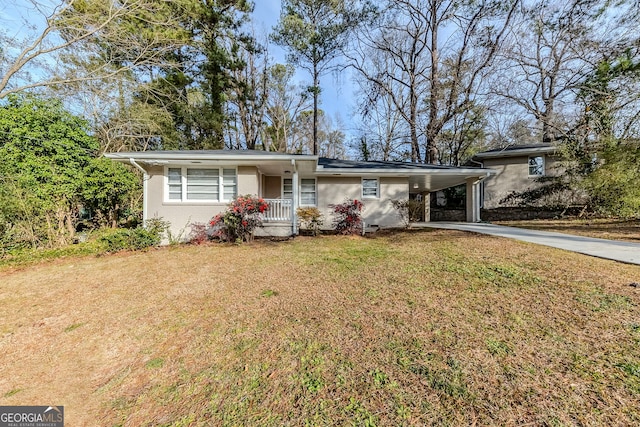 ranch-style house featuring a carport and a front lawn