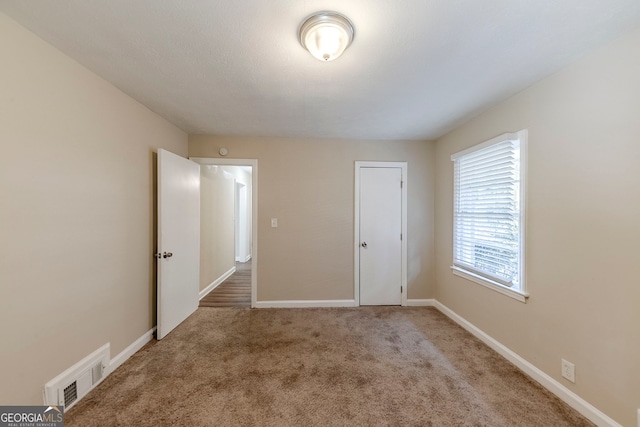 unfurnished bedroom with carpet floors and a closet