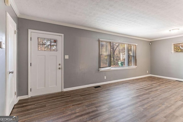 entrance foyer with crown molding, dark hardwood / wood-style floors, and a textured ceiling