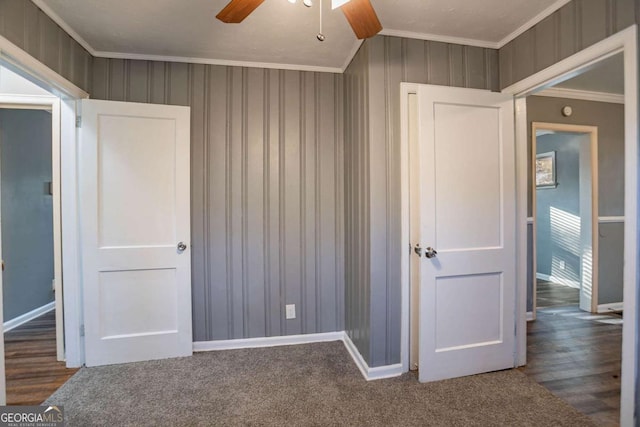 unfurnished bedroom with carpet, ceiling fan, and ornamental molding