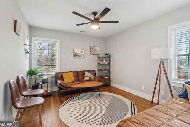 living room with wood-type flooring and ceiling fan