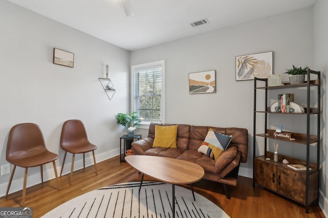 living area with hardwood / wood-style flooring