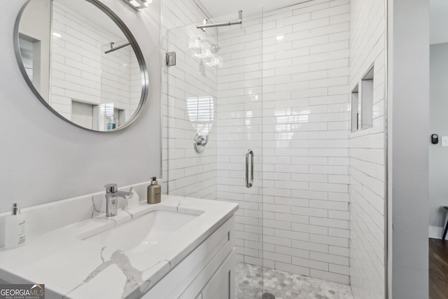 bathroom with a shower with door and vanity