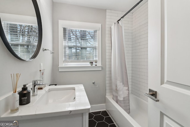 bathroom with shower / bath combo, tile patterned floors, and vanity