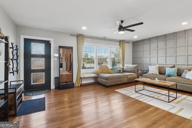 living room with ceiling fan and hardwood / wood-style floors