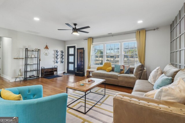 living room featuring ceiling fan and wood-type flooring