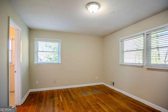 spare room with dark hardwood / wood-style flooring