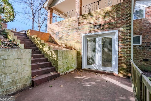 view of exterior entry with a patio and french doors