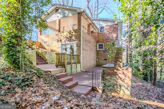 back of property featuring a balcony