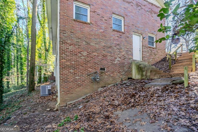 view of side of property featuring central AC