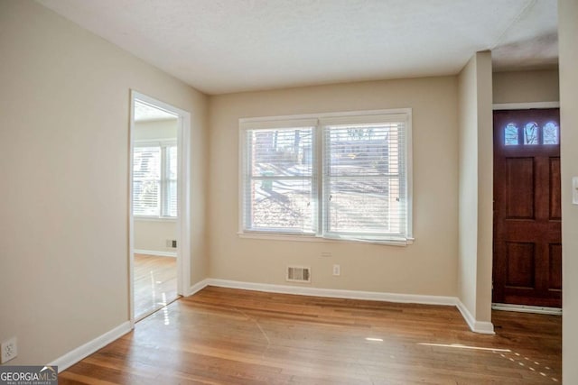 foyer featuring a wealth of natural light and light hardwood / wood-style flooring