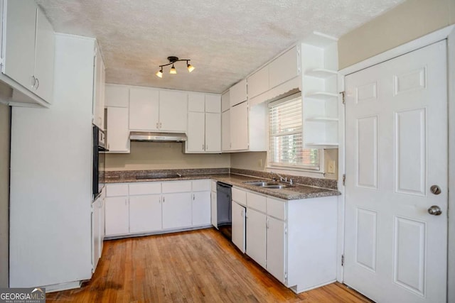 kitchen featuring sink, white cabinetry, light hardwood / wood-style floors, and black appliances