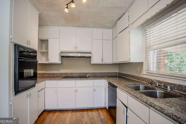 kitchen with sink, black appliances, light wood-type flooring, and white cabinets