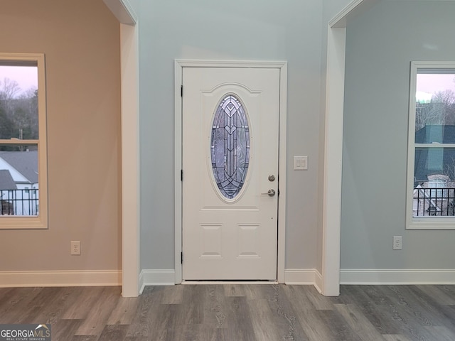 entryway with dark hardwood / wood-style flooring