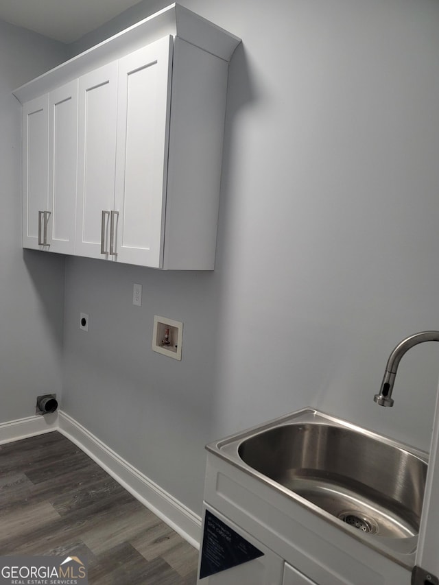 clothes washing area with sink, hookup for a washing machine, dark hardwood / wood-style floors, cabinets, and hookup for an electric dryer