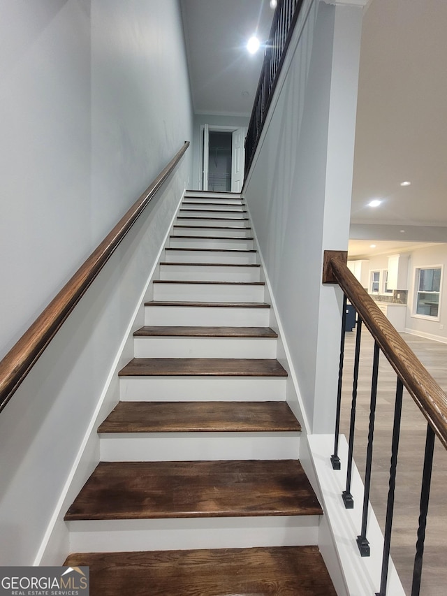 staircase with hardwood / wood-style floors