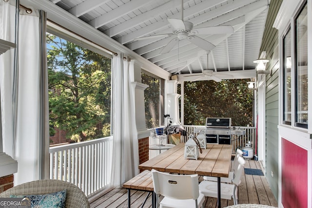 sunroom / solarium featuring ceiling fan and vaulted ceiling with beams